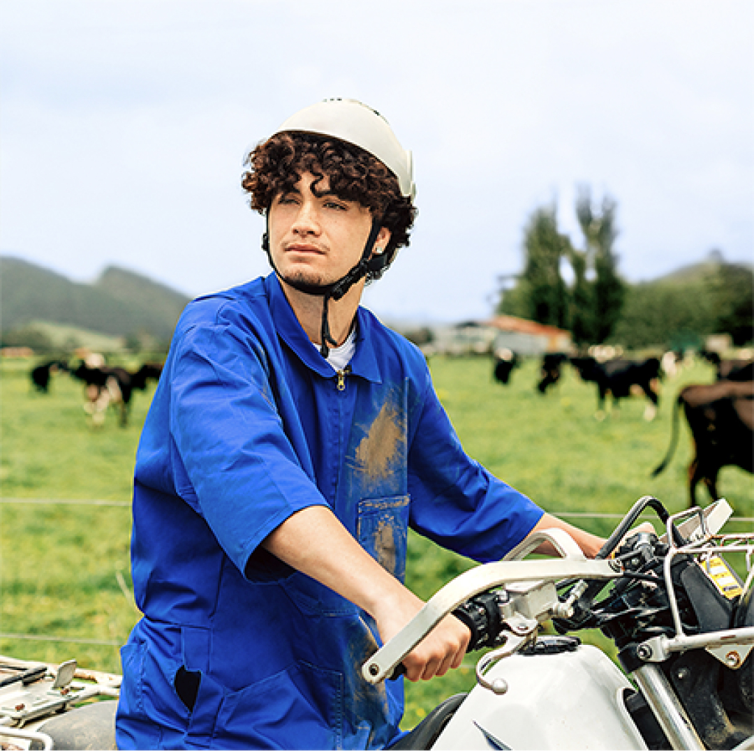 dairy worker on a motorbike